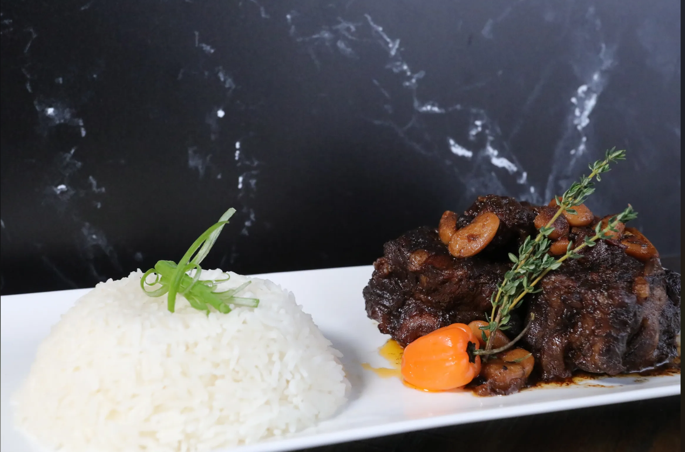 Perfect Seasoning is known for its Carribbean-inspired menu, which includes Oxtails and Jamaican Jerk Smoked Chicken. Photo Credit: Perfect Seasoning Website.